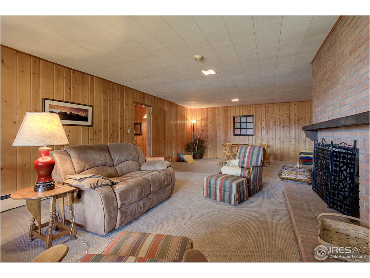 1498 Marshall Road Boulder, CO 80305 - Photo 24 of 40 a living room with furniture a fireplace and a table