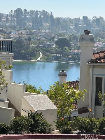 an aerial view of residential houses with outdoor space and lake view