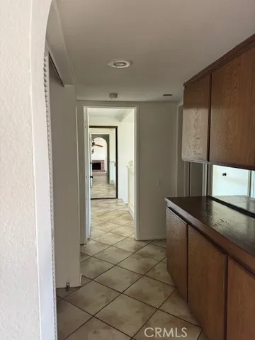 a hallway with cabinets and window