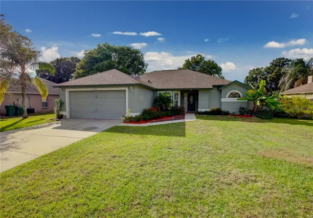 a front view of a house with yard and garage