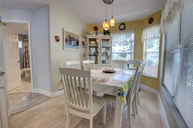 a view of a dining room with furniture wooden floor and chandelier