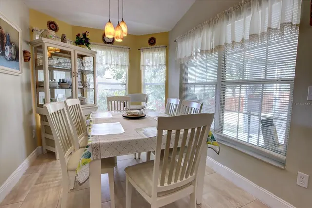 a bedroom with a bed window and a tv