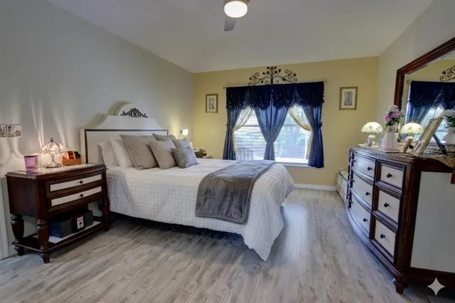 a bathroom with a granite countertop sink a mirror a vanity and a shower