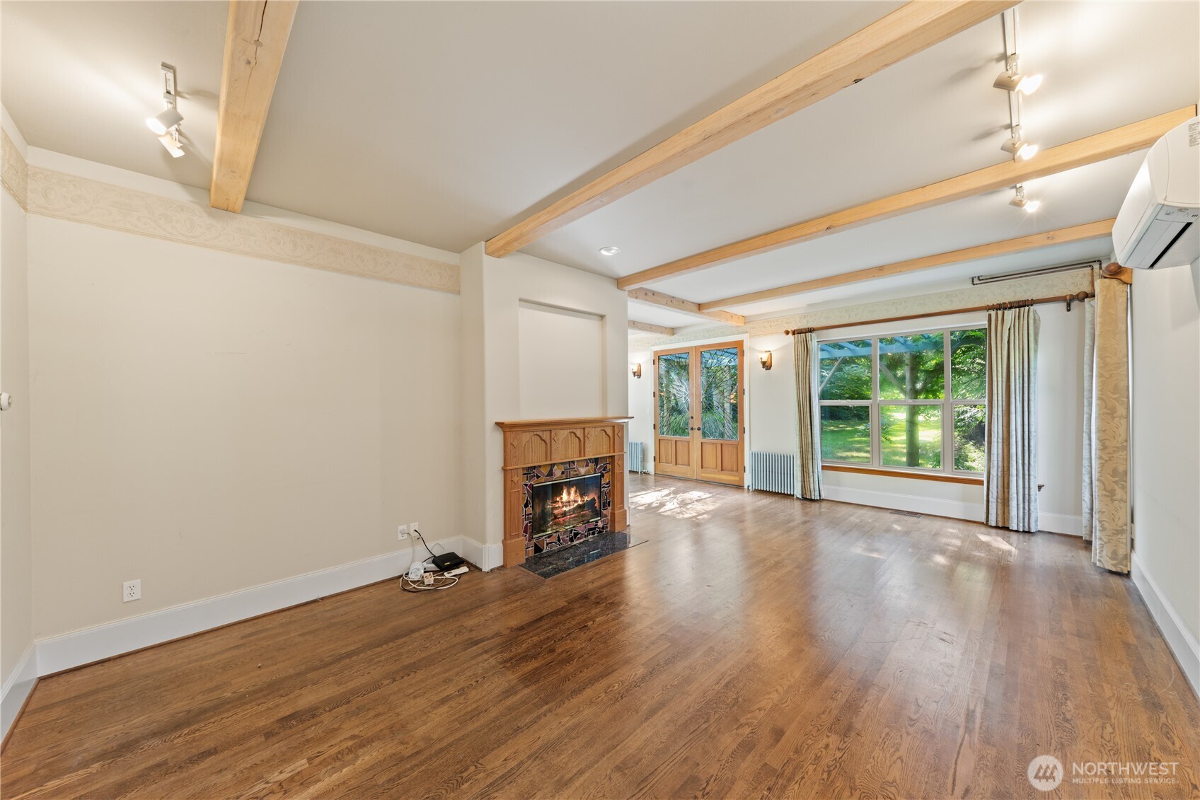 5513 Homestead Lane Anacortes, WA 98221 - Photo 7 of 37 a view of empty room with wooden floor and fireplace
