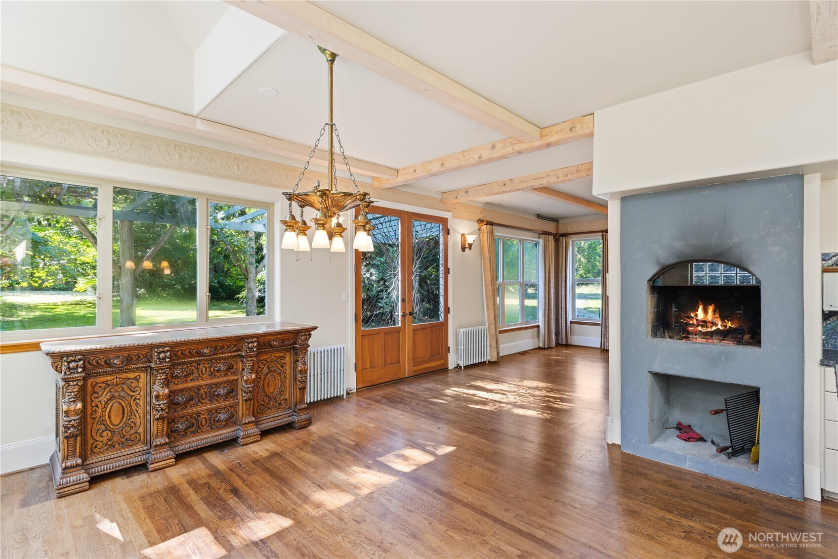 5513 Homestead Lane Anacortes, WA 98221 - Photo 9 of 37 a view of an entryway with wooden floor a fireplace and a window