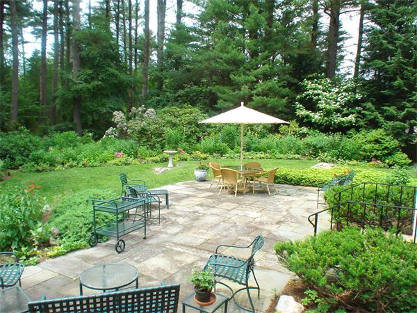 141 Montvale Road Weston, MA 02493 - Photo 3 of 29 a view of backyard with seating space and trees in the background