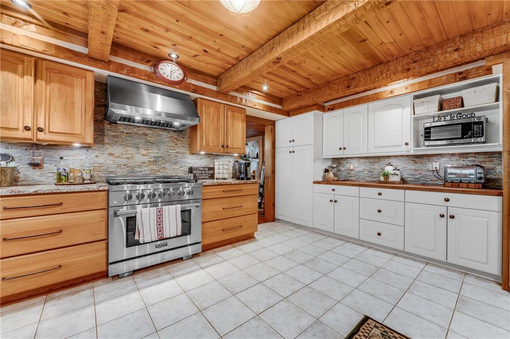 2162 Garards Fort Road Waynesburg, PA 15370 - Photo 26 of 50 a kitchen with stainless steel appliances granite countertop a stove a sink and a microwave