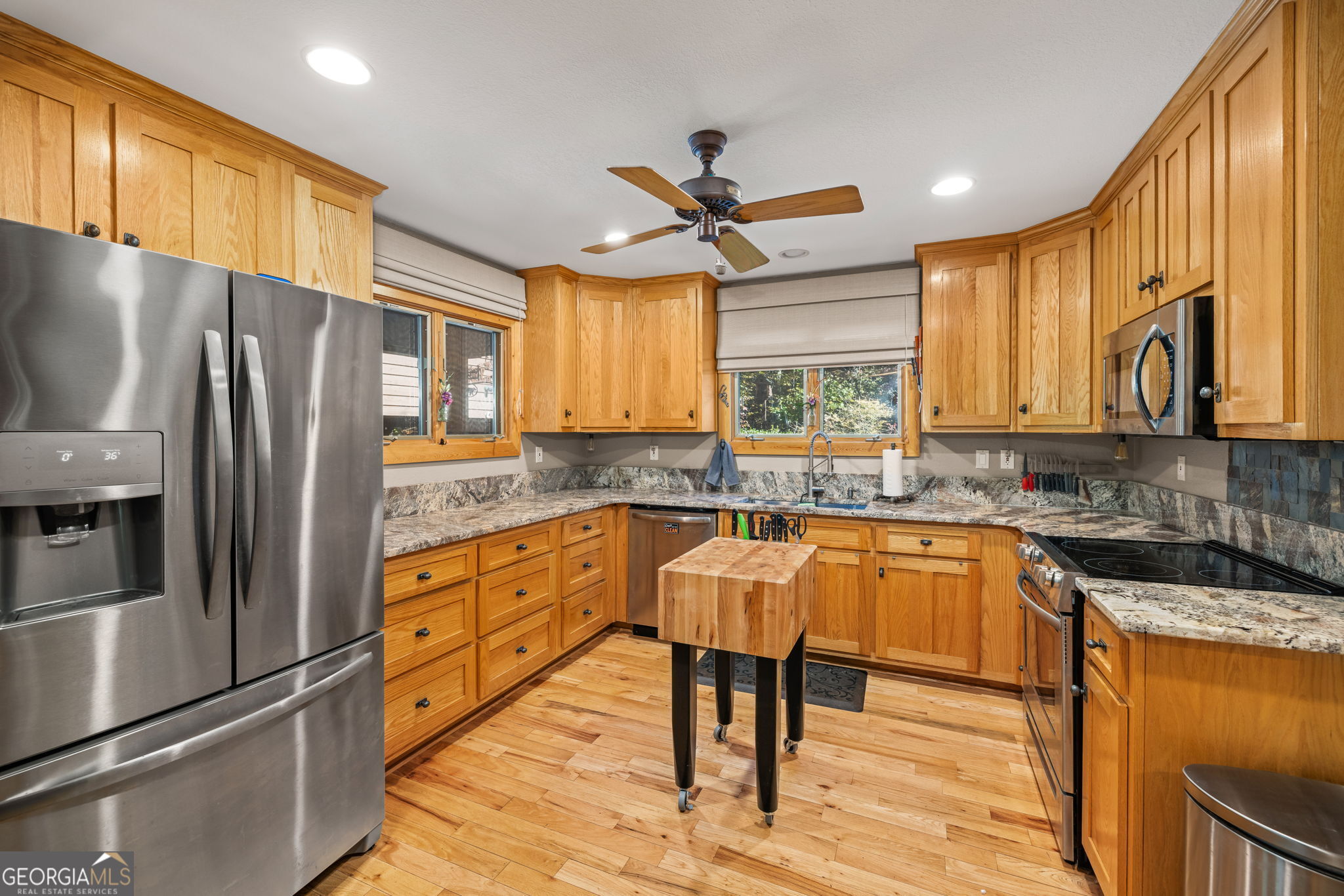 1010 Mdw Vw Ridge Clarkesville, GA 30523 - Photo 13 of 56 a kitchen with stainless steel appliances granite countertop a refrigerator a sink dishwasher a stove and white countertops with wooden floor