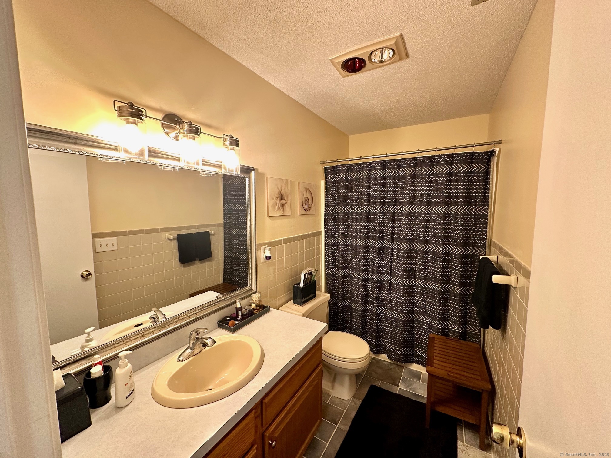 489 Wolcott Street, Unit 25 Bristol, CT 06010 - Photo 12 of 14 a bathroom with a sink mirror vanity and toilet