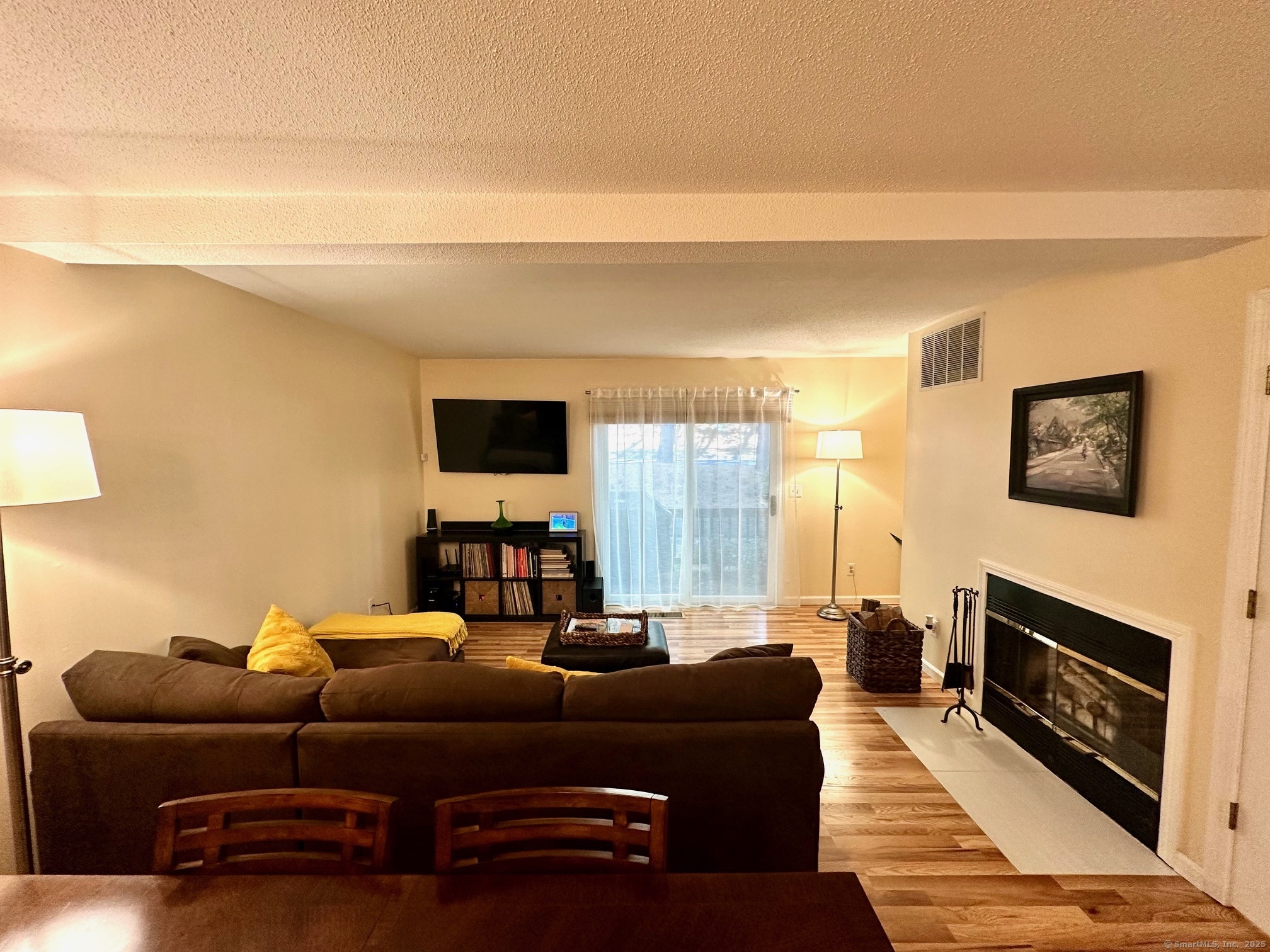 489 Wolcott Street, Unit 25 Bristol, CT 06010 - Photo 4 of 14 a living room with furniture a flat screen tv and a fireplace