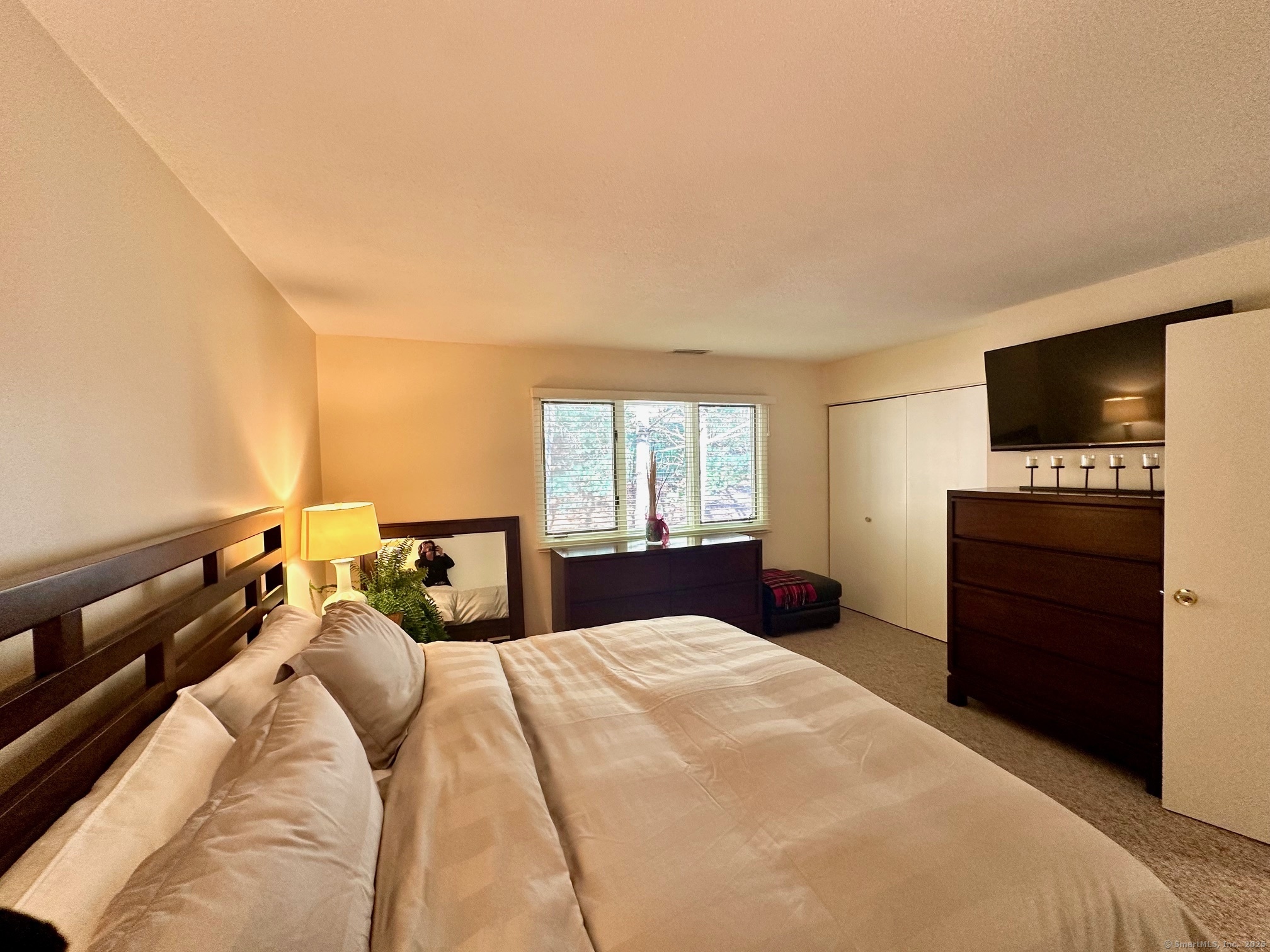 489 Wolcott Street, Unit 25 Bristol, CT 06010 - Photo 10 of 14 a bedroom with a bed and a flat screen tv