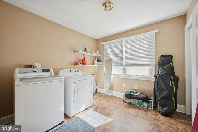 a kitchen with stainless steel appliances granite countertop a stove a sink dishwasher and a refrigerator with wooden floor