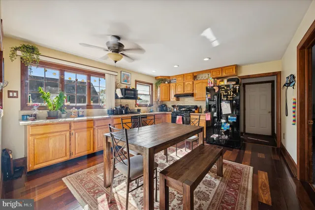 a view of a dining room with a table and chairs