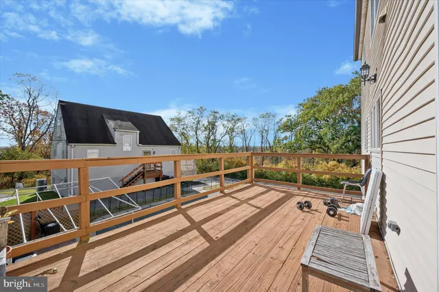 a bedroom with a bed a dresser and potted plants on the dresser