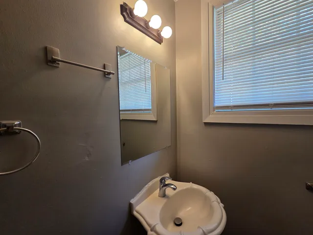 a bathroom with a sink and mirror
