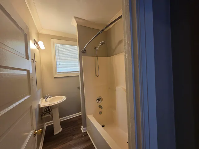 a bathroom with a tub shower and a sink