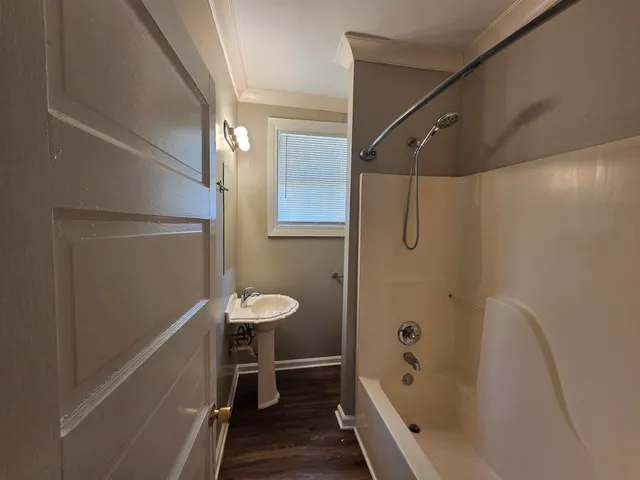 a bathroom with a tub shower and a sink