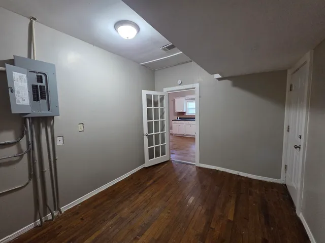 an empty room with wooden floor and closet