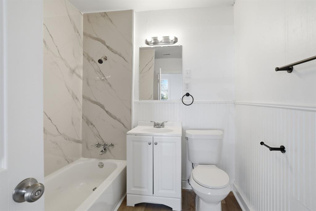 604 East Morton Street Denison, TX 75021 - Photo 12 of 22 a bathroom with a sink a toilet and shower