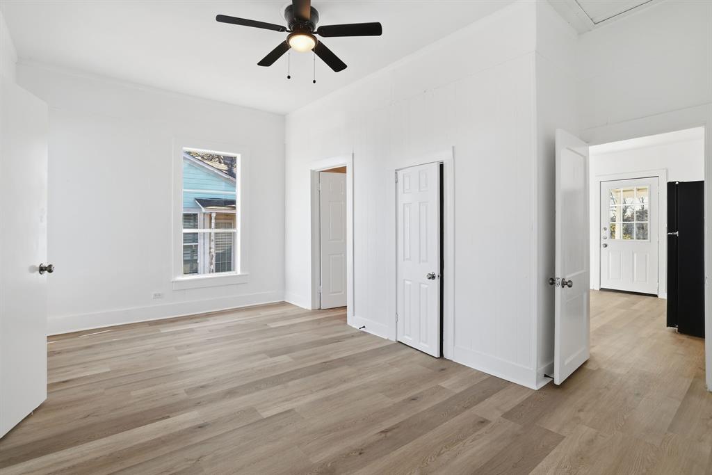 604 East Morton Street Denison, TX 75021 - Photo 10 of 22 a view of empty room with wooden floor and window