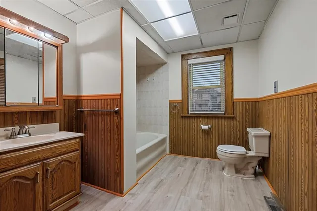 a bathroom with a sink a toilet a mirror and shower