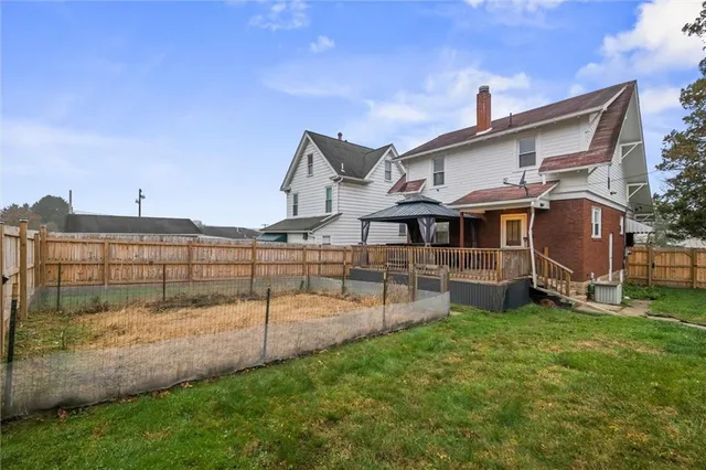 a view of a house with a yard and sitting area