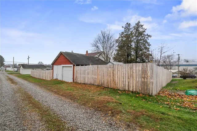 a view of a house with backyard and trees