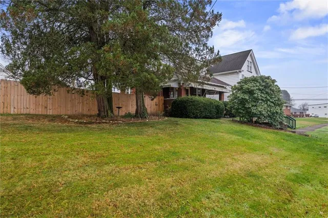 a front view of house with yard and trees