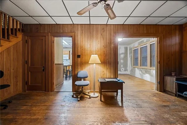 a living room with furniture a flat screen tv and a table