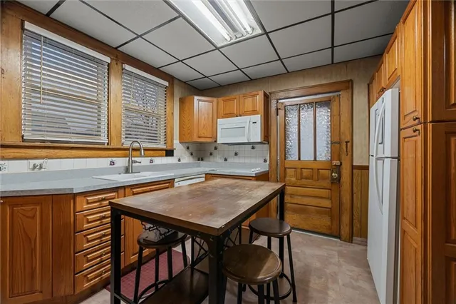 a view of a kitchen with a table and chairs