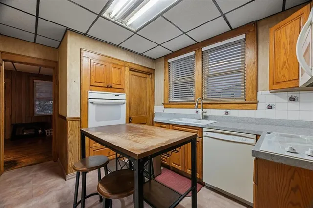 a kitchen with a table chairs sink and cabinets