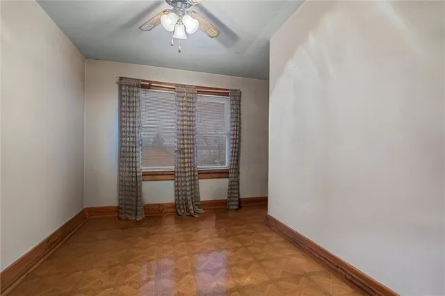 an empty room with chair and a window