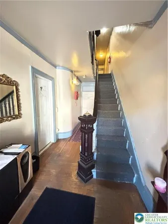 a view of entryway and hall with wooden floor