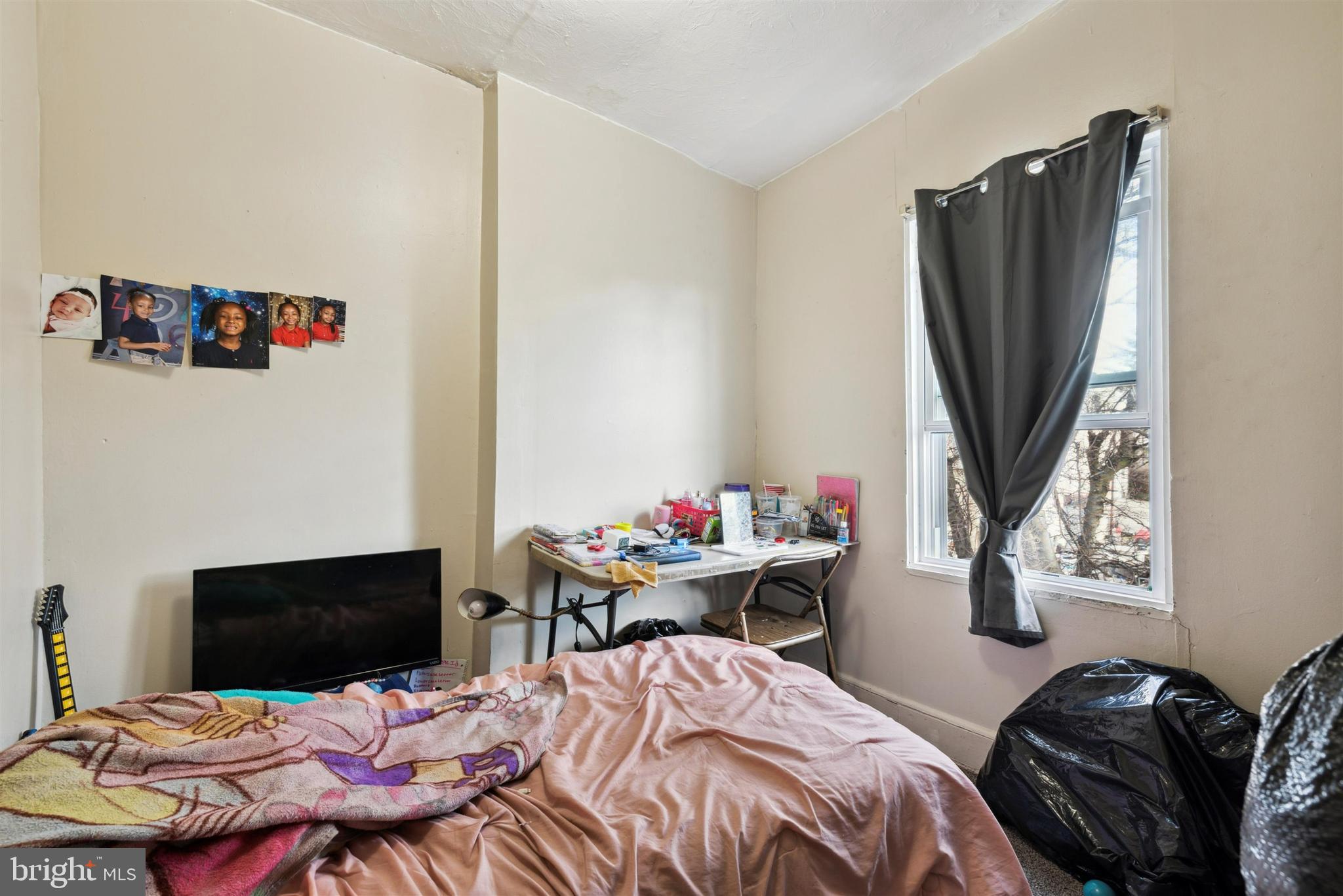 6124 Upland Street Philadelphia, PA 19142 - Photo 11 of 15 a bedroom that has a bed and a table in it
