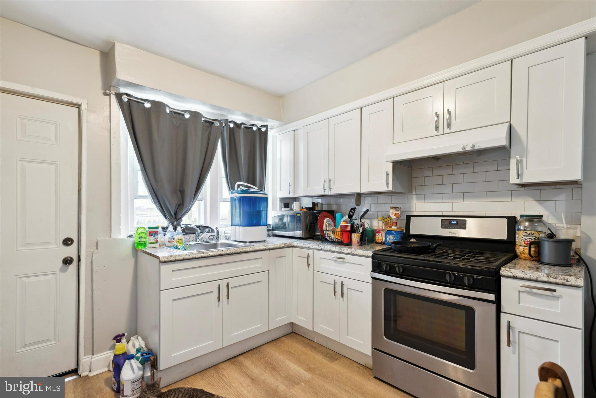 6124 Upland Street Philadelphia, PA 19142 - Photo 4 of 15 a kitchen with a sink stove and cabinets