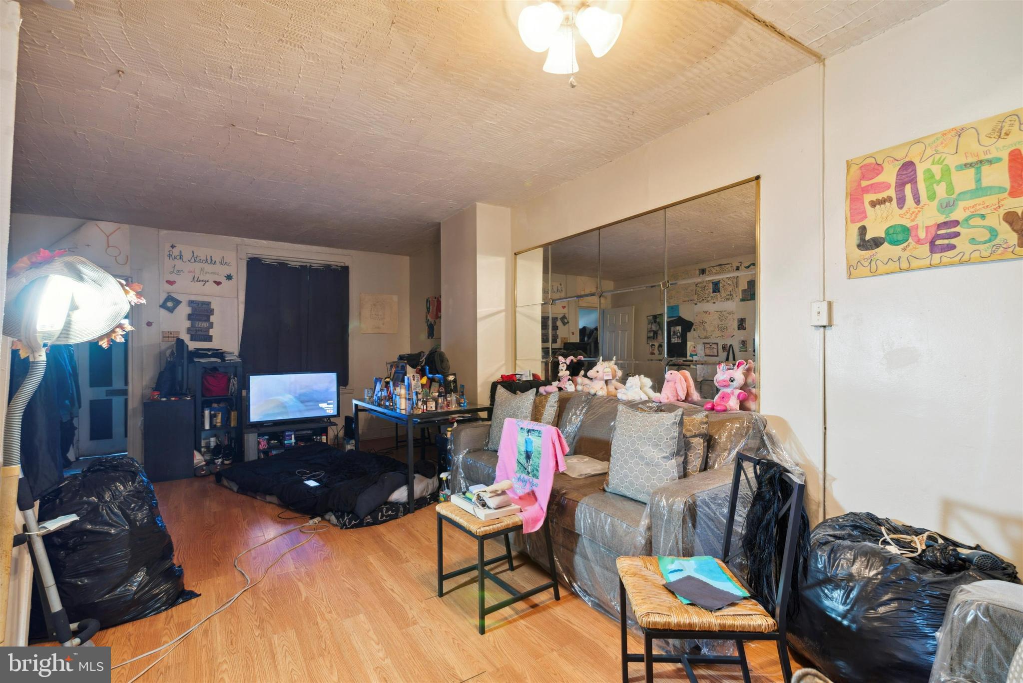 6124 Upland Street Philadelphia, PA 19142 - Photo 6 of 15 a living room with furniture and a mirror