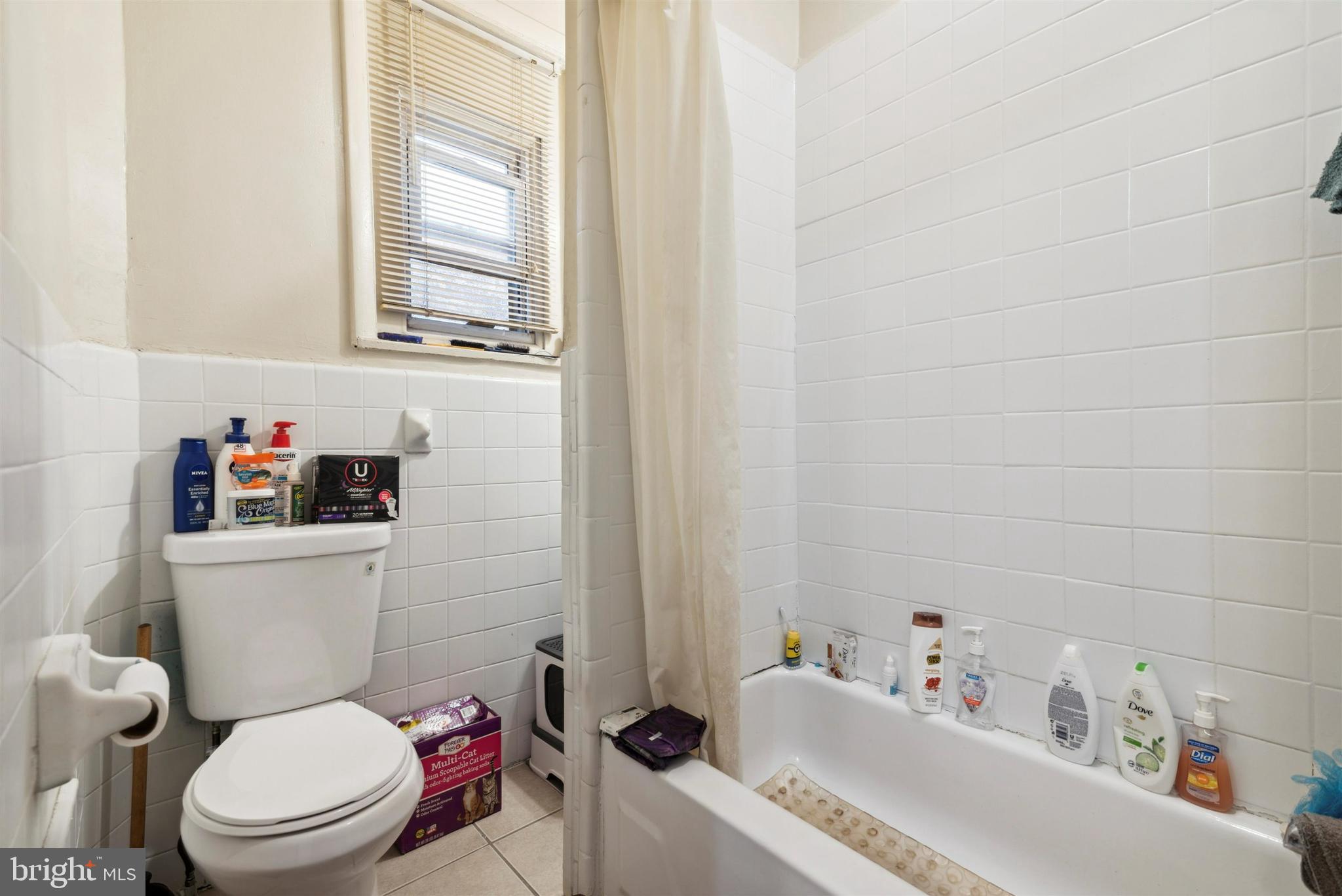 6124 Upland Street Philadelphia, PA 19142 - Photo 10 of 15 a white toilet sitting next to a bathroom sink