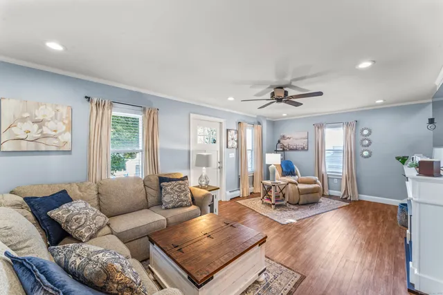 a living room with furniture and wooden floor