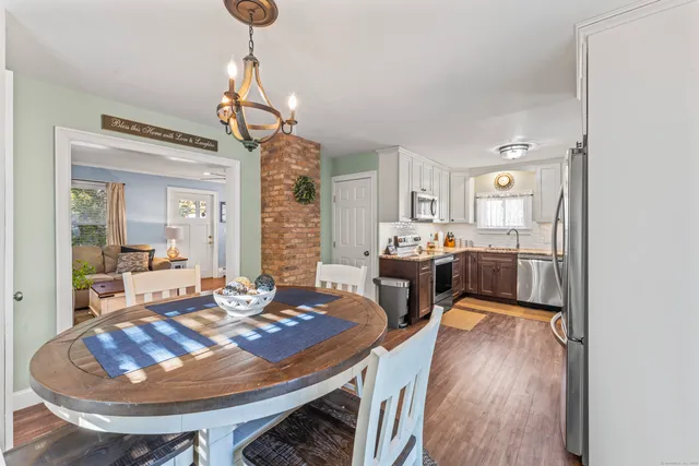 a view of a dining room with furniture and a chandelier