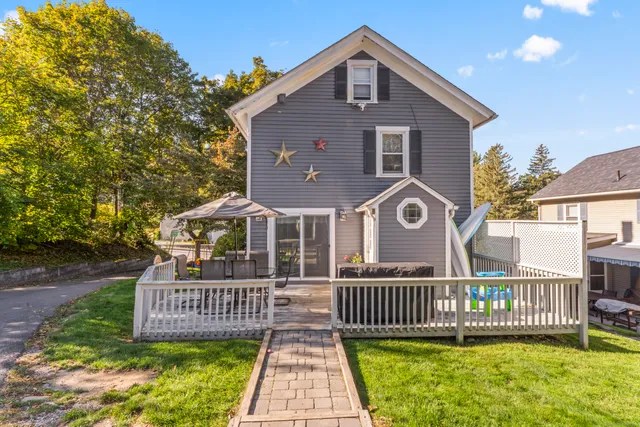 a front view of a house with a garden