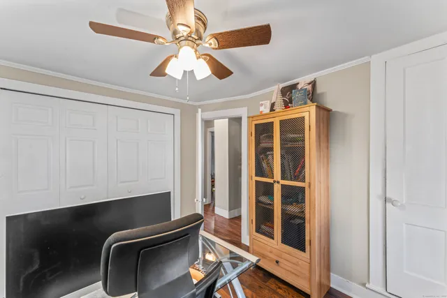 a room with furniture and a chandelier fan