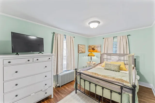 a bedroom with furniture and a flat screen tv