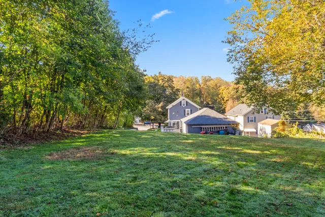 a view of a big yard with a house in the background