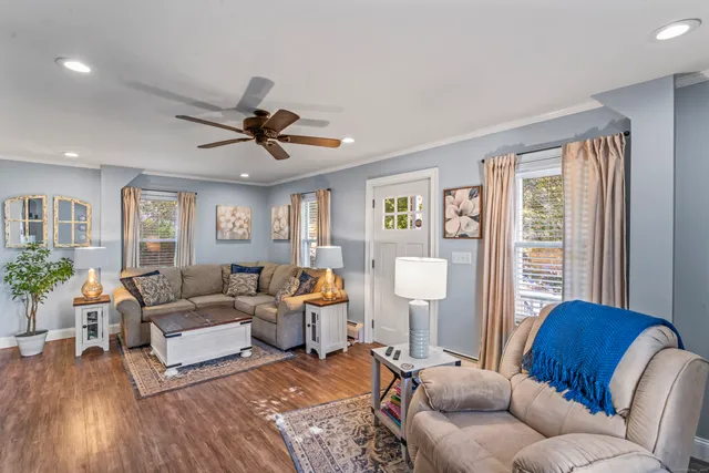 a living room with furniture and wooden floor