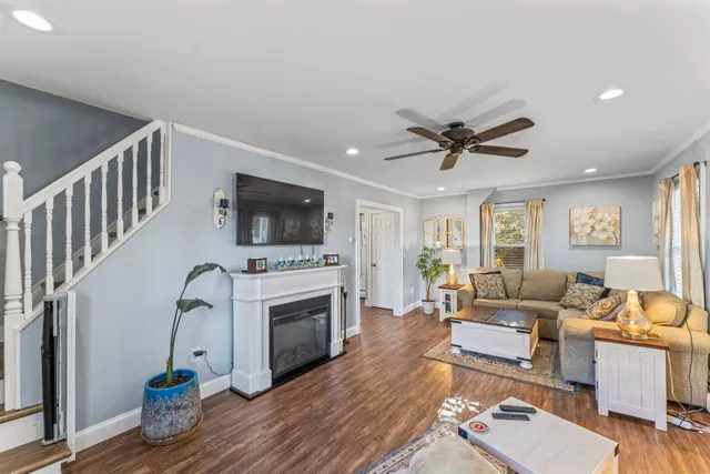 a living room with furniture a fireplace and a flat screen tv