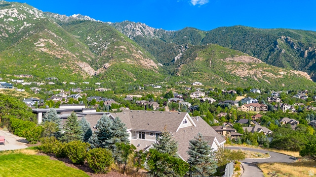 3 Carriagewood Cove, Unit 1088 Sandy, UT 84092 - Photo 78 of 79 Mountain backdrop showcasing a residential area with varied rooflines and a mix of mature trees and landscaping