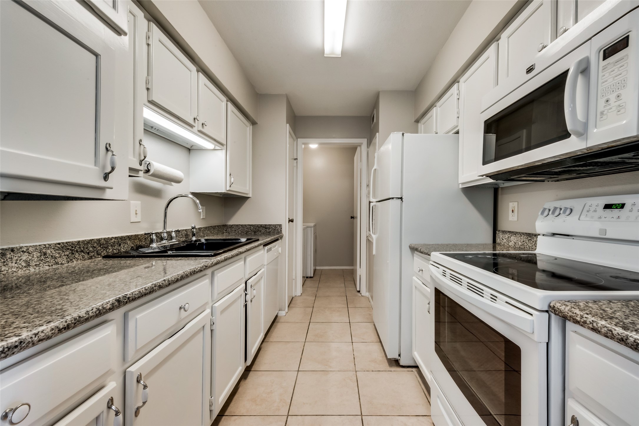 8787 Brae Acres Road, Unit 406 Houston, TX 77074 - Photo 6 of 15 a kitchen with stainless steel appliances granite countertop a stove and a microwave