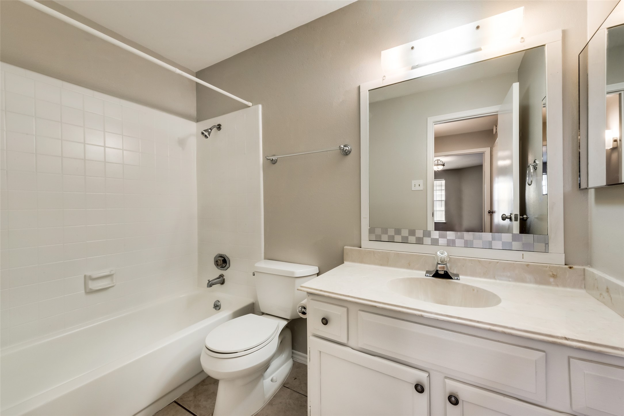 8787 Brae Acres Road, Unit 406 Houston, TX 77074 - Photo 10 of 15 a bathroom with a sink a toilet and shower