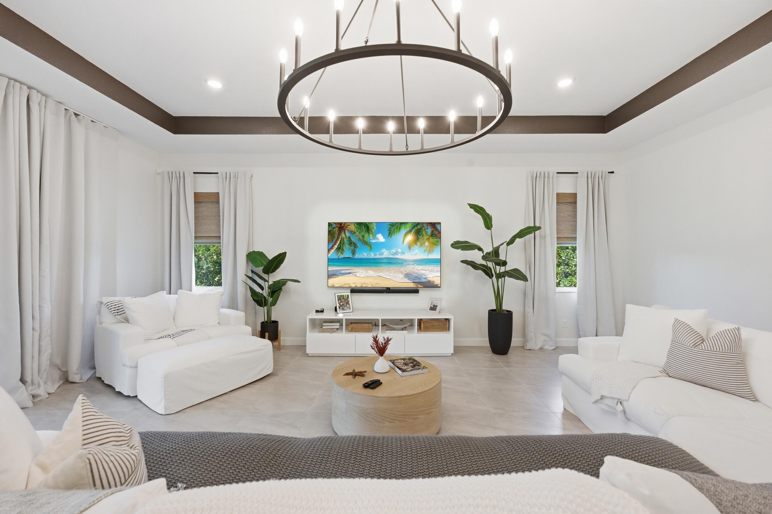 19230 Rolling Acres Road Loxahatchee, FL 33470 - Photo 10 of 58 a living room with furniture a mirror and a chandelier