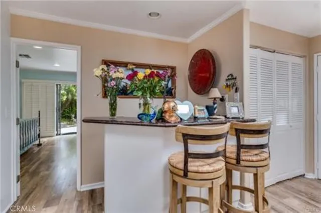 a kitchen with kitchen island granite countertop a sink cabinets and stainless steel appliances